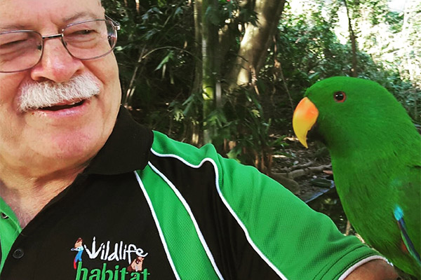 Charles Woodward with an Eclectus parrot at Wildlife Habitat Port Douglas